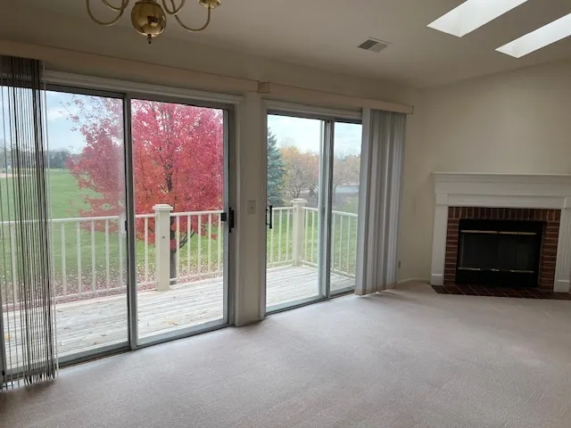 a view of an empty room with glass door