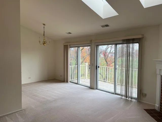 a view of an empty room with windows