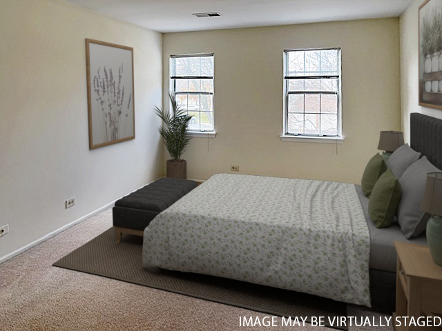 307 Glasgow Lane, Unit V2 Schaumburg, IL 60107 - Photo 8 of 15 a bedroom with a bed and windows