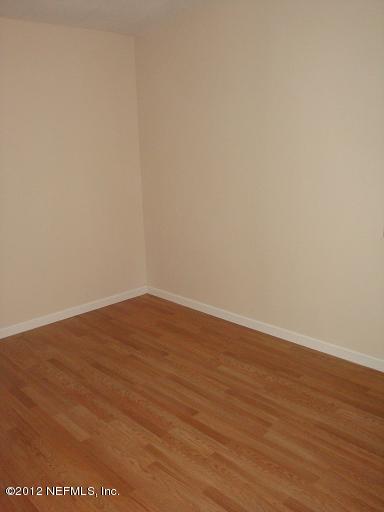 10357 Westmar Road Jacksonville, FL 32218 - Photo 3 of 9 a view of an empty room with wooden floor