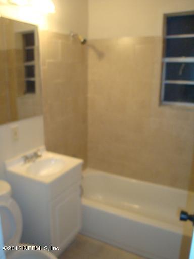 10357 Westmar Road Jacksonville, FL 32218 - Photo 6 of 9 a bathroom with a sink a toilet and shower