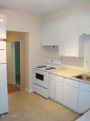 10357 Westmar Road Jacksonville, FL 32218 - Photo 7 of 9 a kitchen with granite countertop white cabinets and white appliances