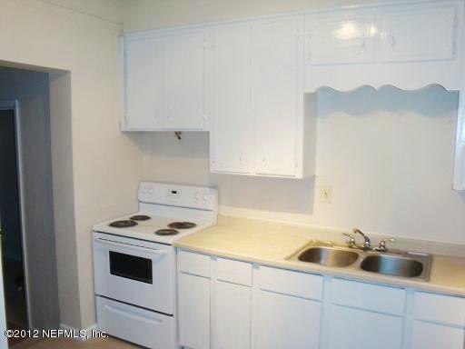 10357 Westmar Road Jacksonville, FL 32218 - Photo 8 of 9 a kitchen with white cabinets and white appliances