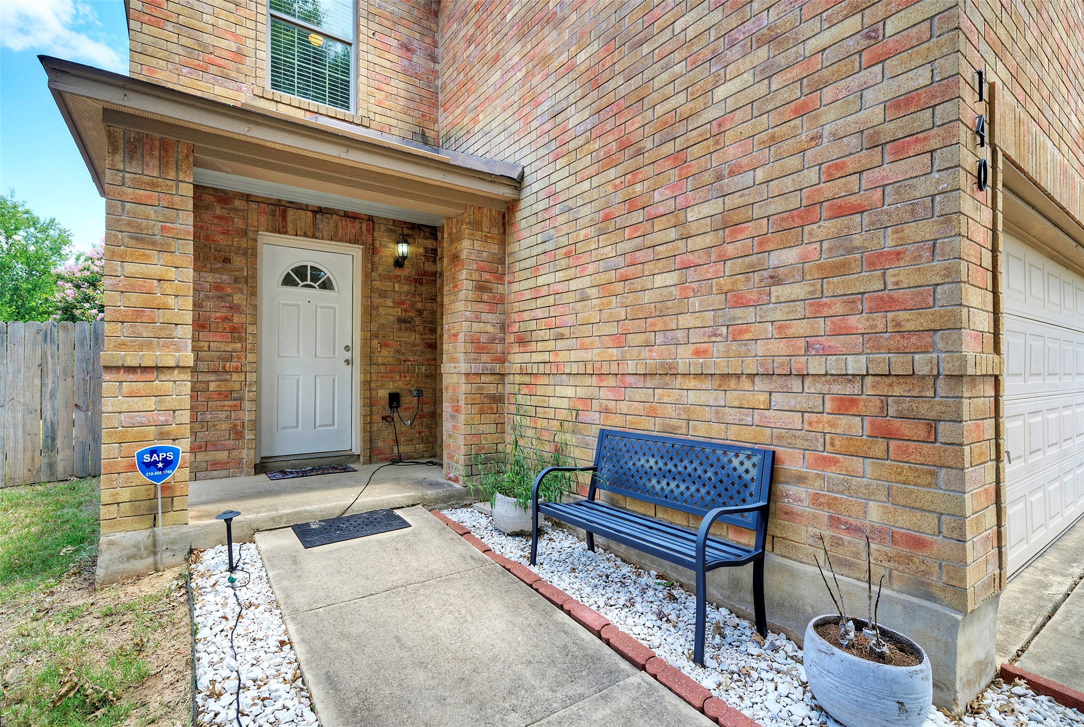 140 Plum Path Kyle, TX 78640 - Photo 20 of 22 a brick house with table and chairs in front of it