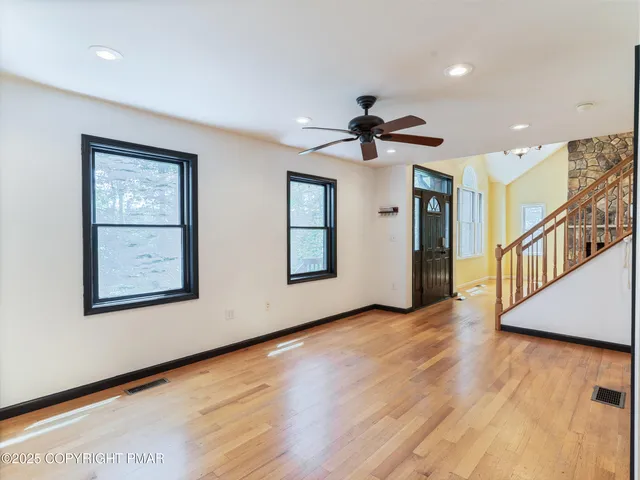 a kitchen with stainless steel appliances granite countertop a sink stove microwave and refrigerator