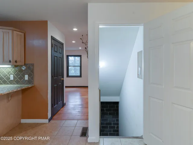 a view of a wooden door with a small yard