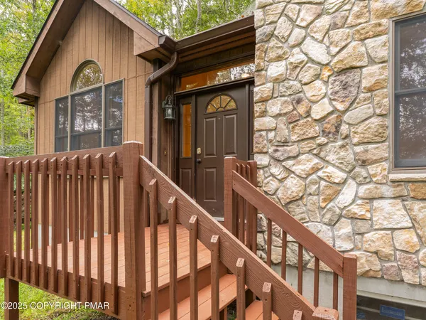 a view of a small house with a yard and outdoor seating