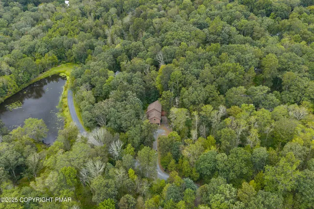 a view of a brick house with a chairs and table in a patio
