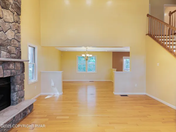 a view of an empty room with brick wall and a window
