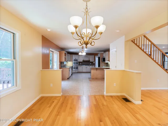 a view of a living room and a chandelier fan