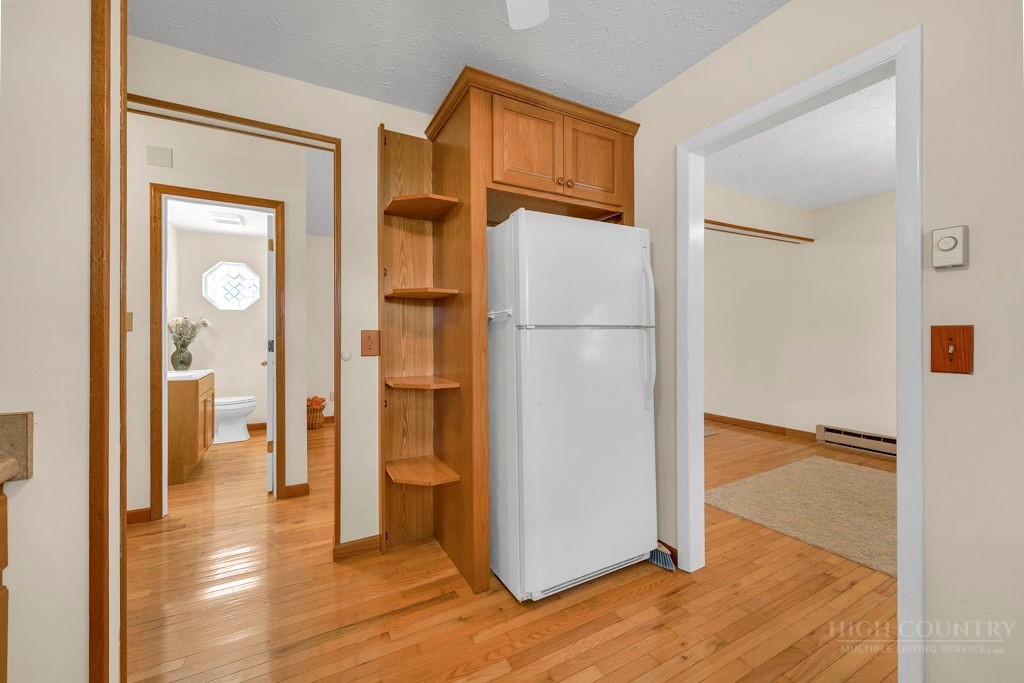 163 Rolling Hill Drive Boone, NC 28607 - Photo 11 of 40 a view of a kitchen with a refrigerator and a wooden floor