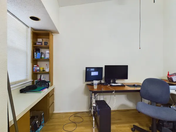 a workspace with furniture and wooden floor