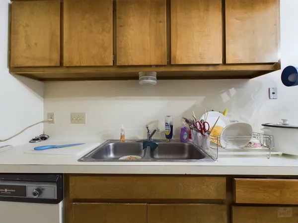 a kitchen with a sink and cabinets
