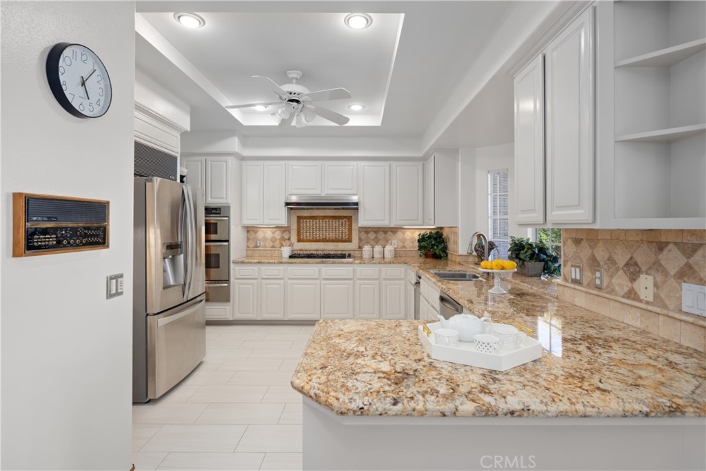 102 Mill Run Monrovia, CA 91016 - Photo 29 of 75 a kitchen with stainless steel appliances granite countertop a refrigerator a stove and a sink