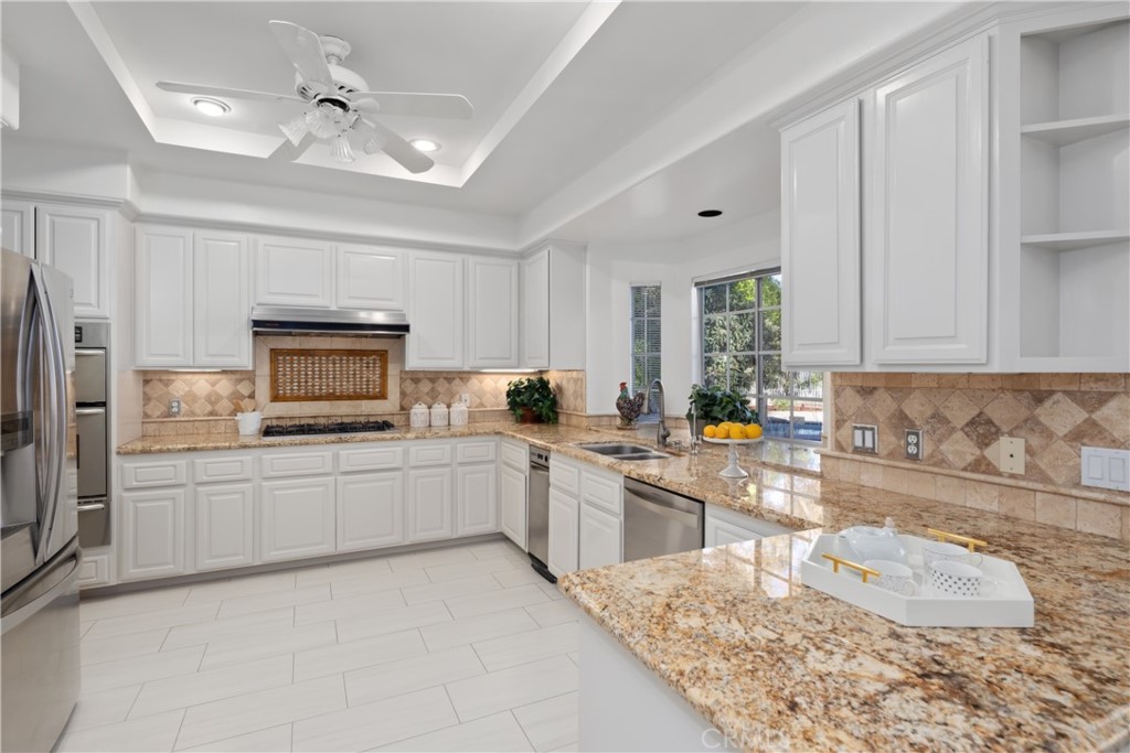 102 Mill Run Monrovia, CA 91016 - Photo 30 of 75 a kitchen with a sink and white cabinets
