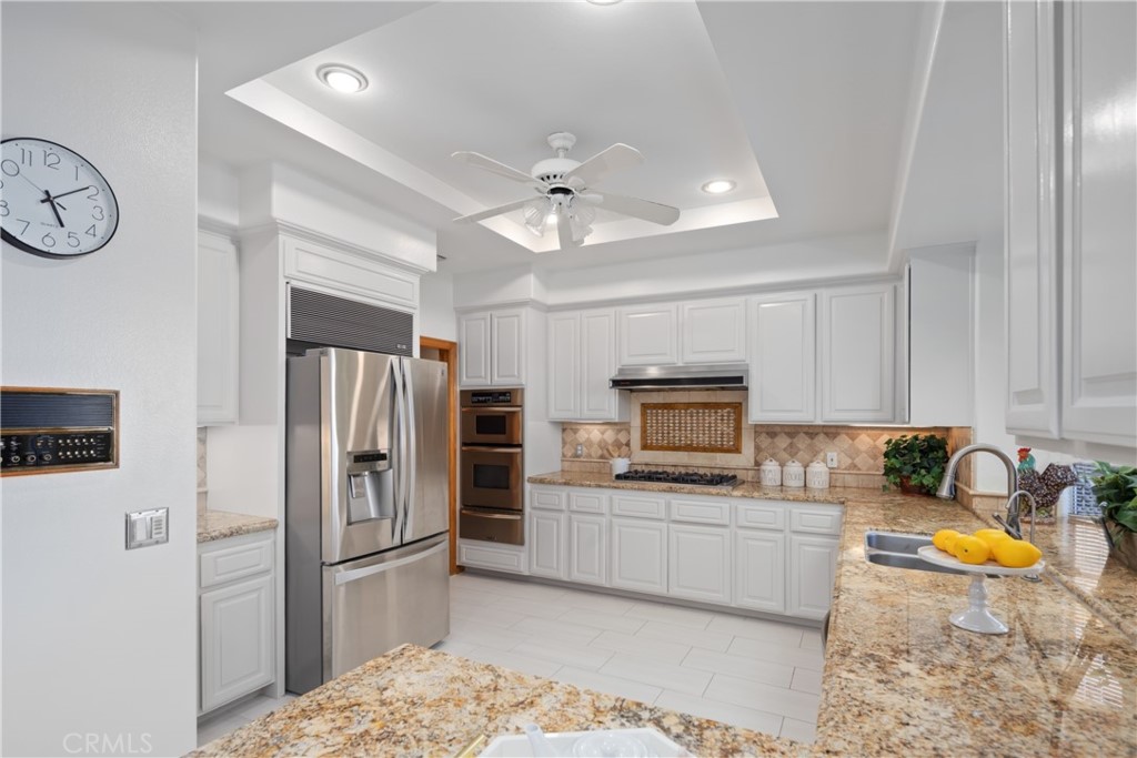 102 Mill Run Monrovia, CA 91016 - Photo 31 of 75 a kitchen with stainless steel appliances granite countertop a refrigerator stove top oven and sink