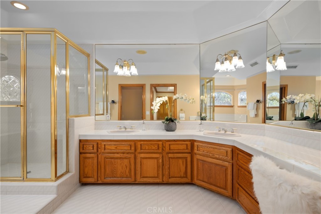 102 Mill Run Monrovia, CA 91016 - Photo 43 of 75 a spacious bathroom with a granite countertop sink a mirror and a shower