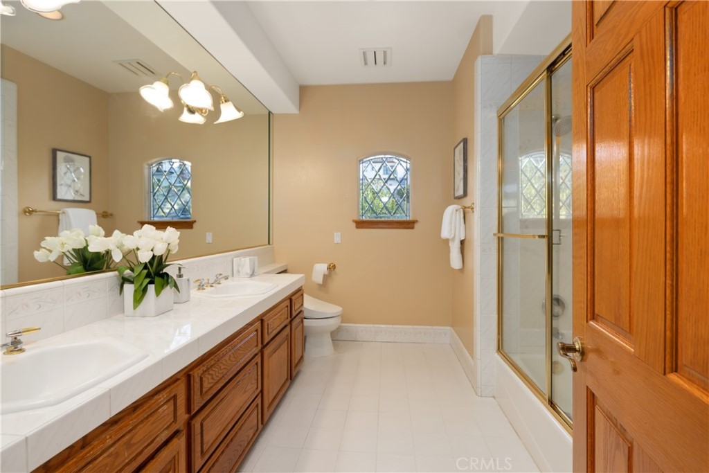 102 Mill Run Monrovia, CA 91016 - Photo 48 of 75 a spacious bathroom with a granite countertop sink a toilet a mirror and shower
