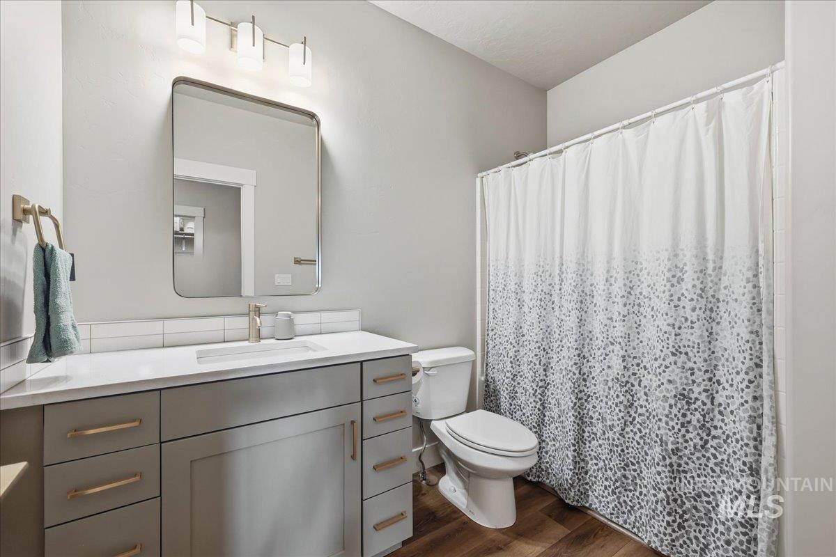 305 Tiffany Rose Way Wilder, ID 83676 - Photo 15 of 31 Bathroom with a shower with curtain, vanity, and dark wood-type flooring
