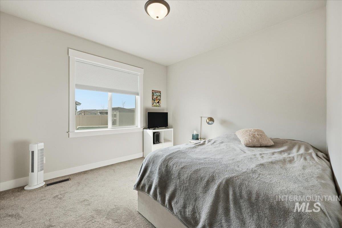 305 Tiffany Rose Way Wilder, ID 83676 - Photo 18 of 31 Carpeted bedroom featuring baseboards