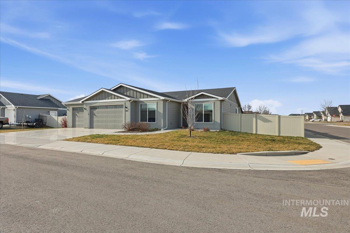 305 Tiffany Rose Way Wilder, ID 83676 - Photo 2 of 31 Ranch-style home featuring concrete driveway, a garage, and board and batten siding