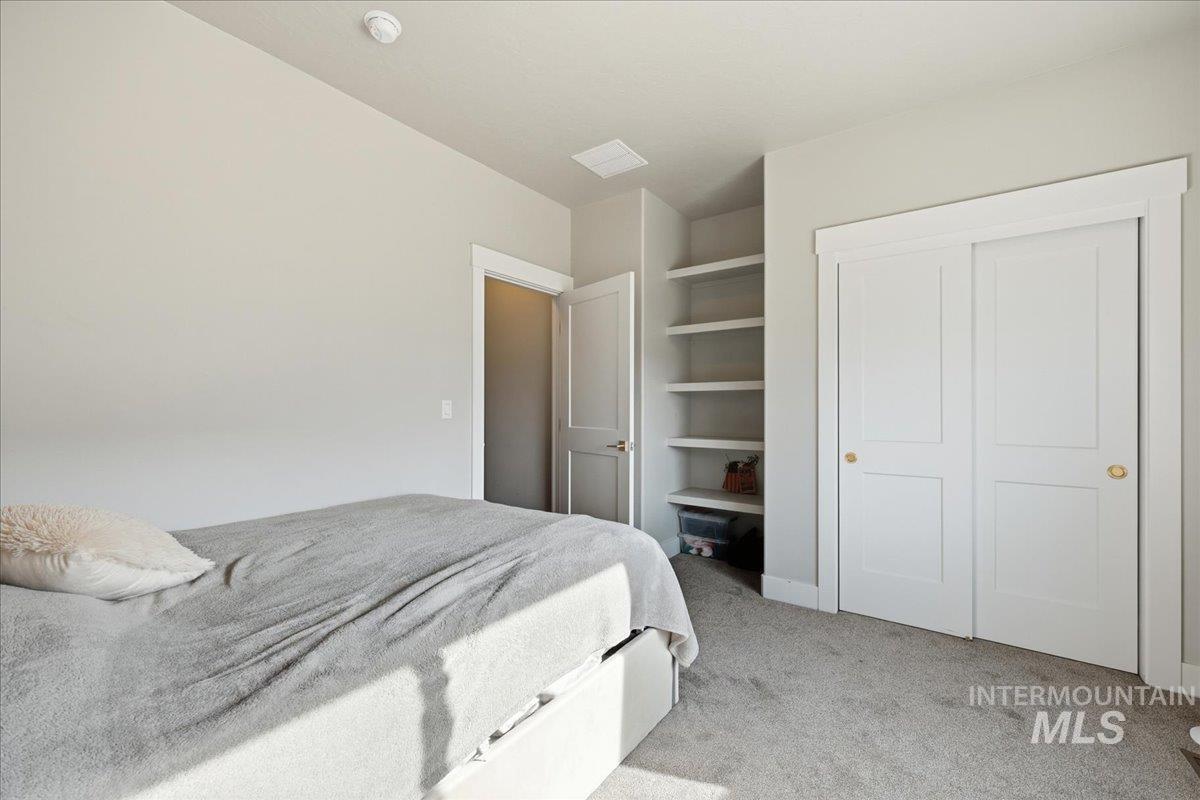 305 Tiffany Rose Way Wilder, ID 83676 - Photo 19 of 31 Bedroom with light carpet and a closet