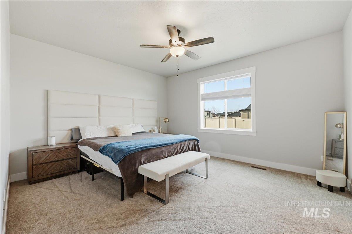 305 Tiffany Rose Way Wilder, ID 83676 - Photo 21 of 31 Bedroom featuring light carpet and ceiling fan