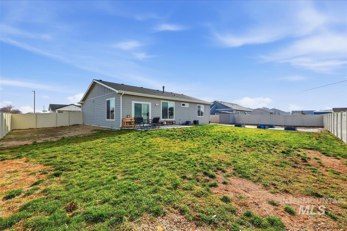305 Tiffany Rose Way Wilder, ID 83676 - Photo 26 of 31 Back of house featuring a fenced backyard and a patio