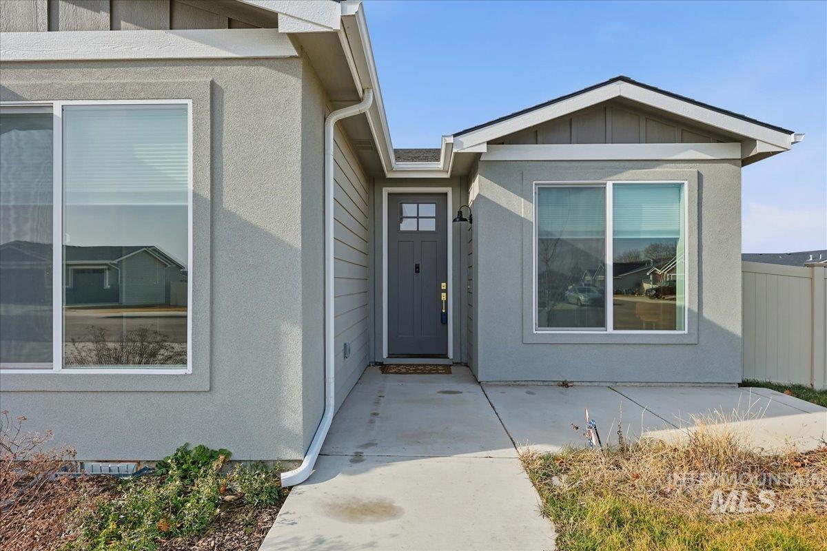 305 Tiffany Rose Way Wilder, ID 83676 - Photo 3 of 31 Doorway to property featuring board and batten siding