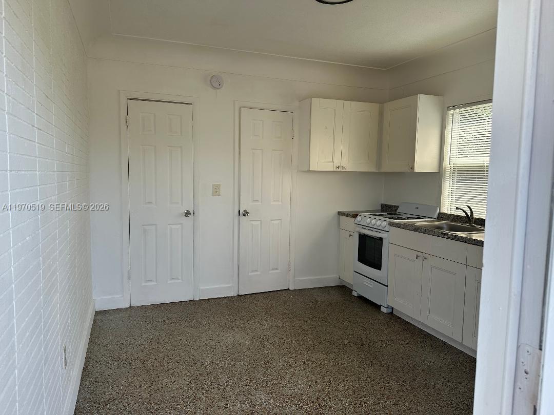 186 Northwest 1st Street, Unit 3 Homestead, FL 33030 - Photo 4 of 6 a view of a kitchen with white cabinets
