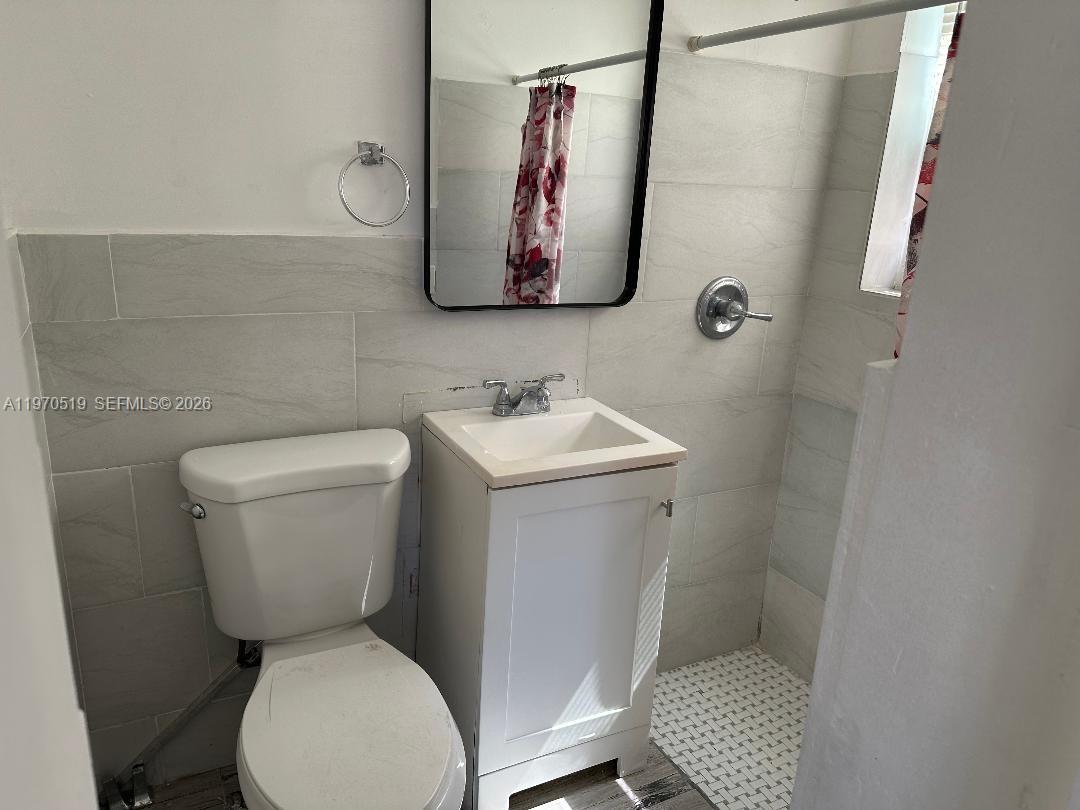 186 Northwest 1st Street, Unit 3 Homestead, FL 33030 - Photo 5 of 6 a white toilet sitting next to a bathroom sink