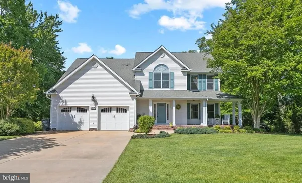a front view of a house with a garden and porch