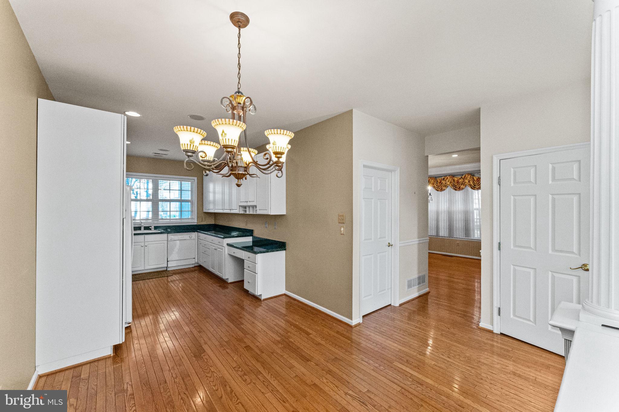 376 Hobson Place Blue Bell, PA 19422 - Photo 11 of 29 a dining hall with a dining table wooden floor and a chandelier
