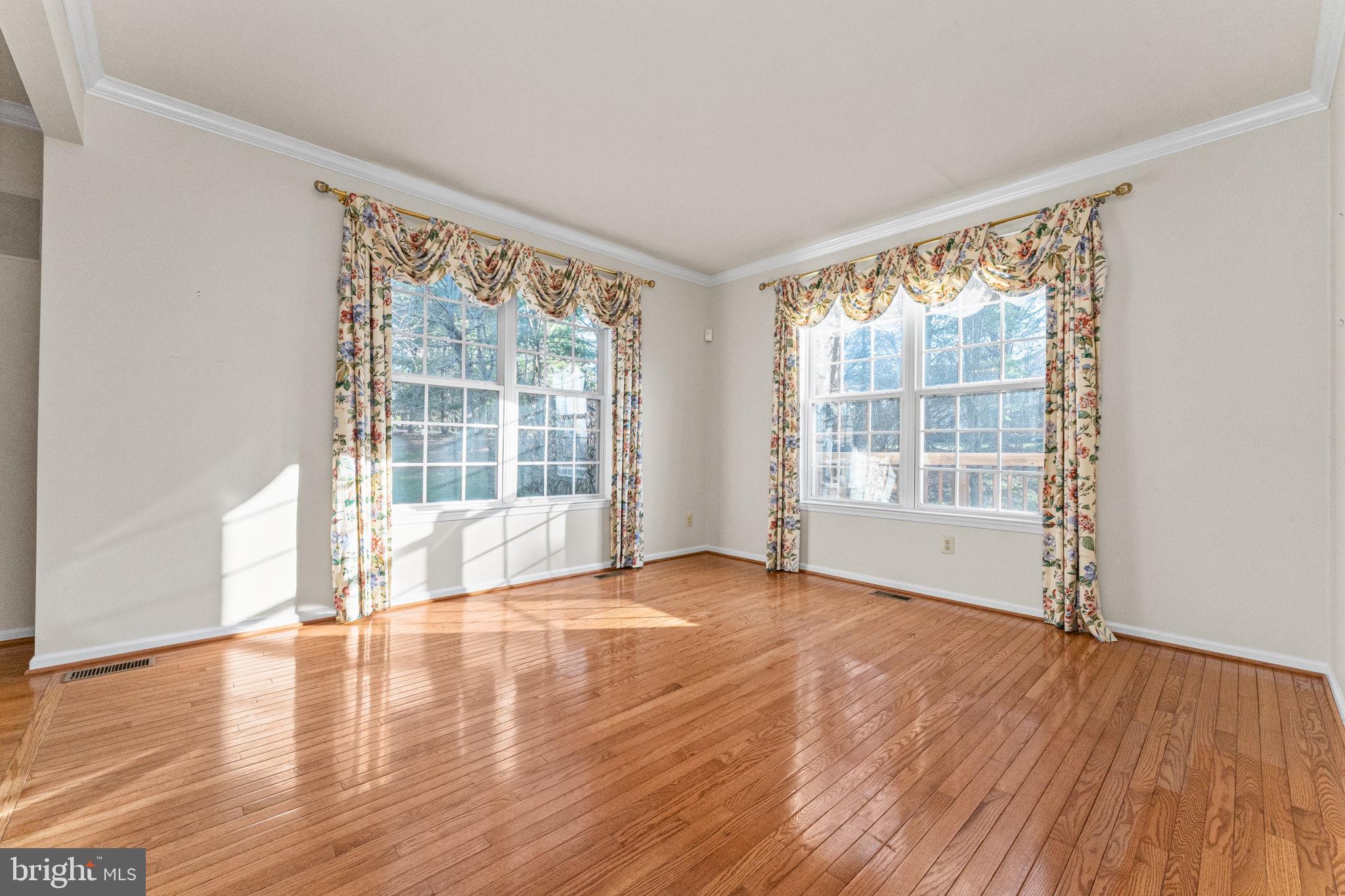 376 Hobson Place Blue Bell, PA 19422 - Photo 13 of 29 a view of an empty room with wooden floor and a window