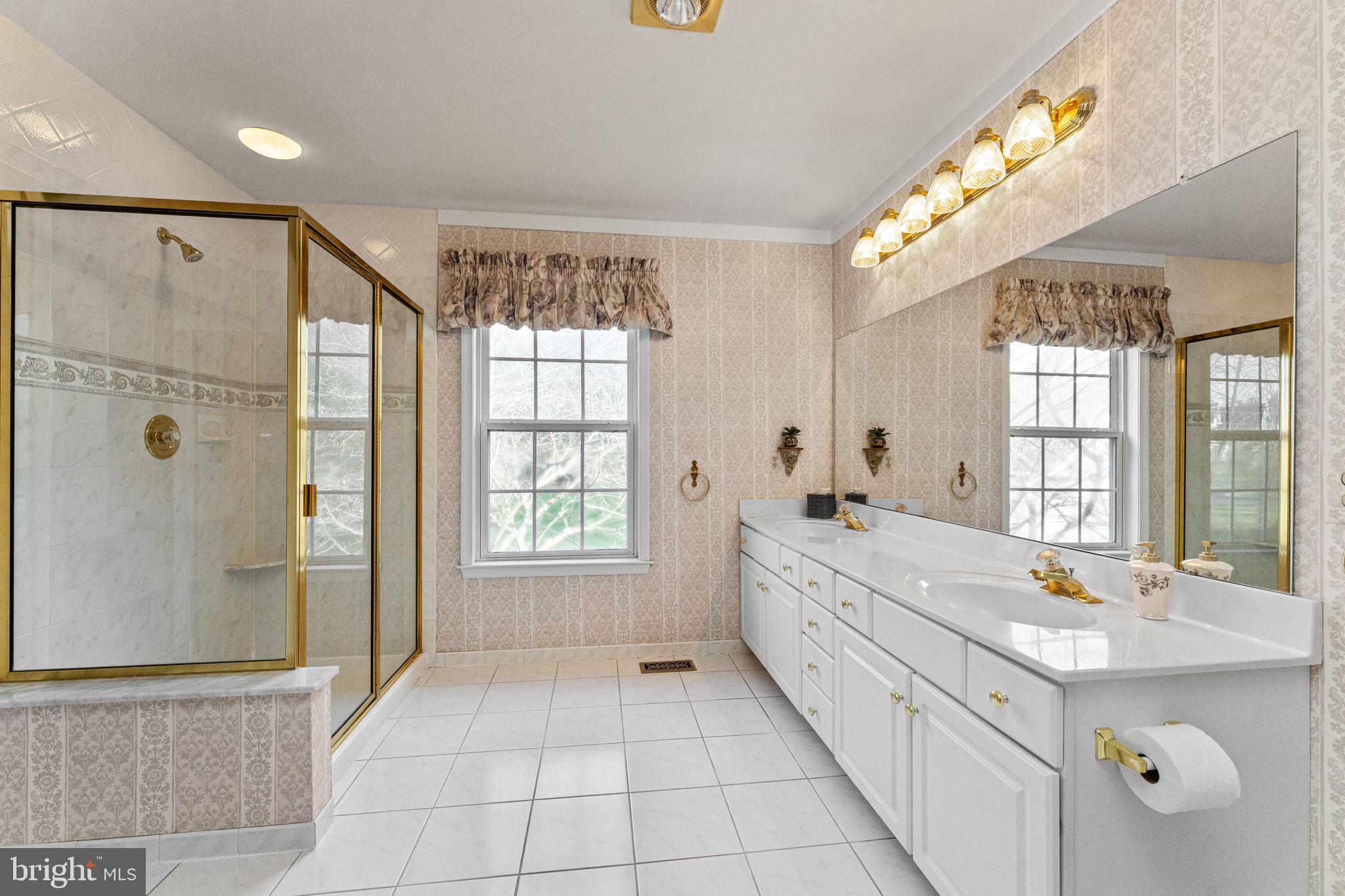 376 Hobson Place Blue Bell, PA 19422 - Photo 20 of 29 a spacious bathroom with a double vanity sink a large mirror and shower