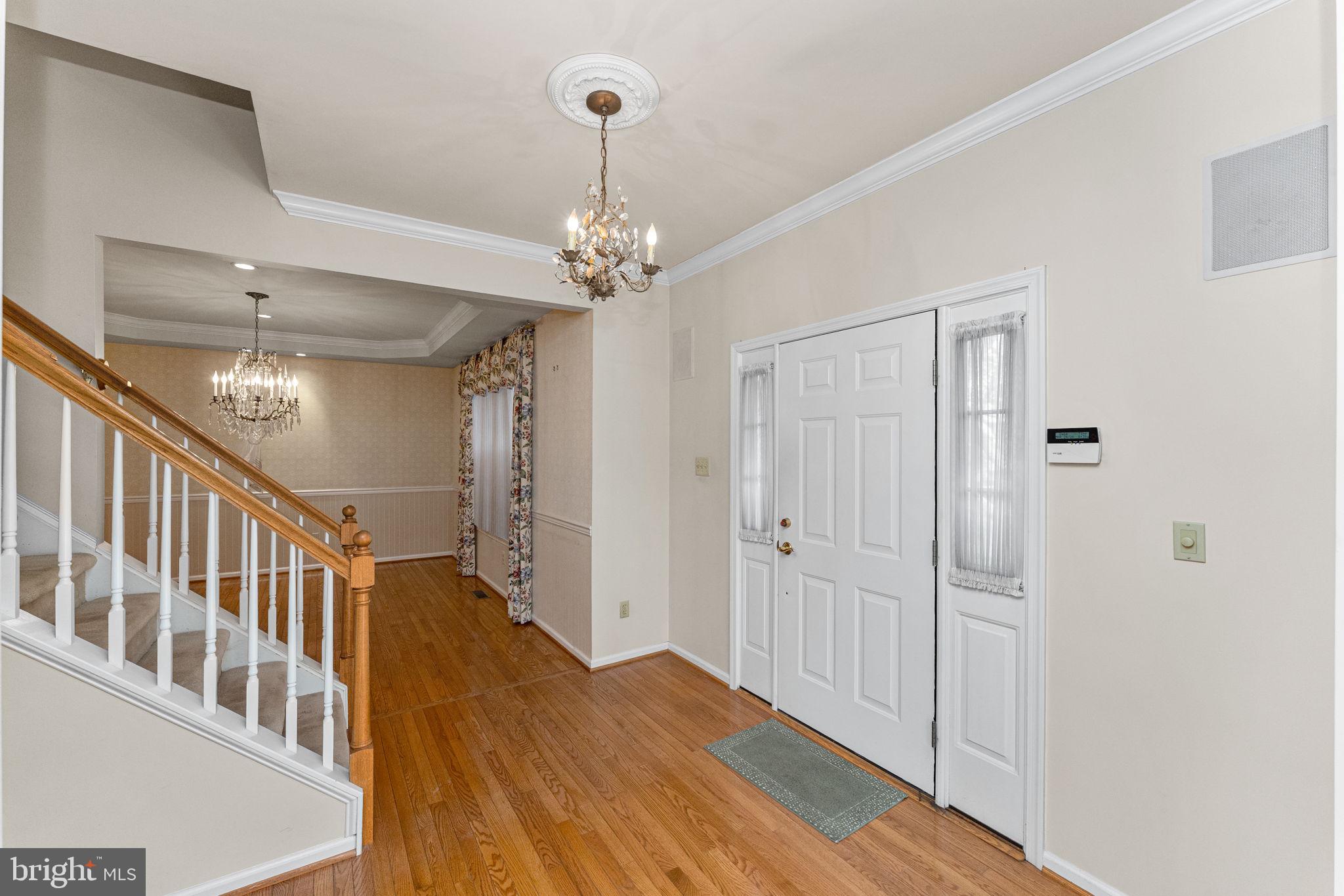 376 Hobson Place Blue Bell, PA 19422 - Photo 4 of 29 a view of a hallway with wooden floor and chandelier