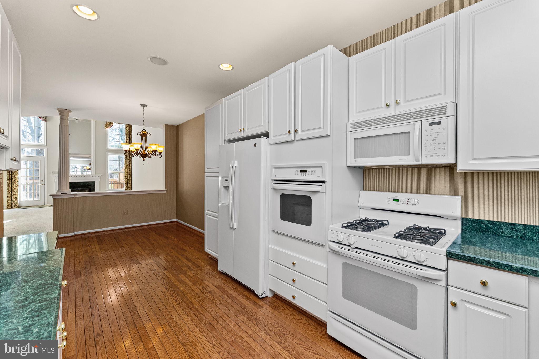 376 Hobson Place Blue Bell, PA 19422 - Photo 10 of 29 a kitchen with granite countertop white cabinets and white appliances