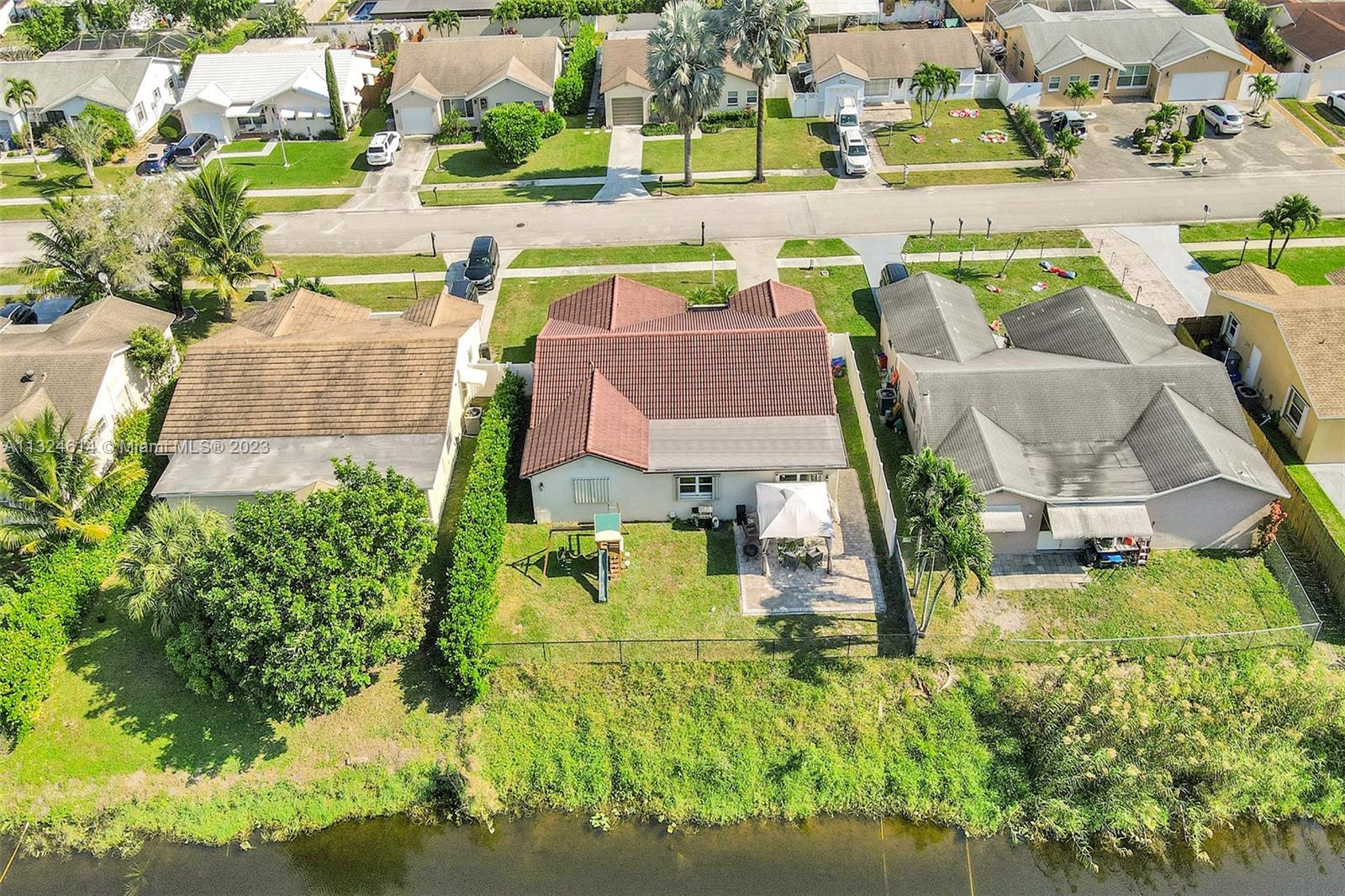 22777 Southwest 56th Avenue Boca Raton, FL 33433 - Photo 27 of 34 an aerial view of a house with swimming pool lawn chairs and yard