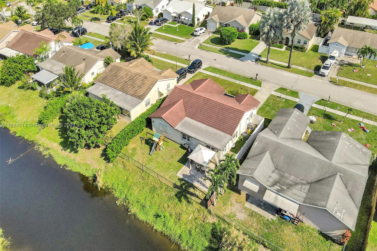 22777 Southwest 56th Avenue Boca Raton, FL 33433 - Photo 28 of 34 an aerial view of a house with a garden and swimming pool