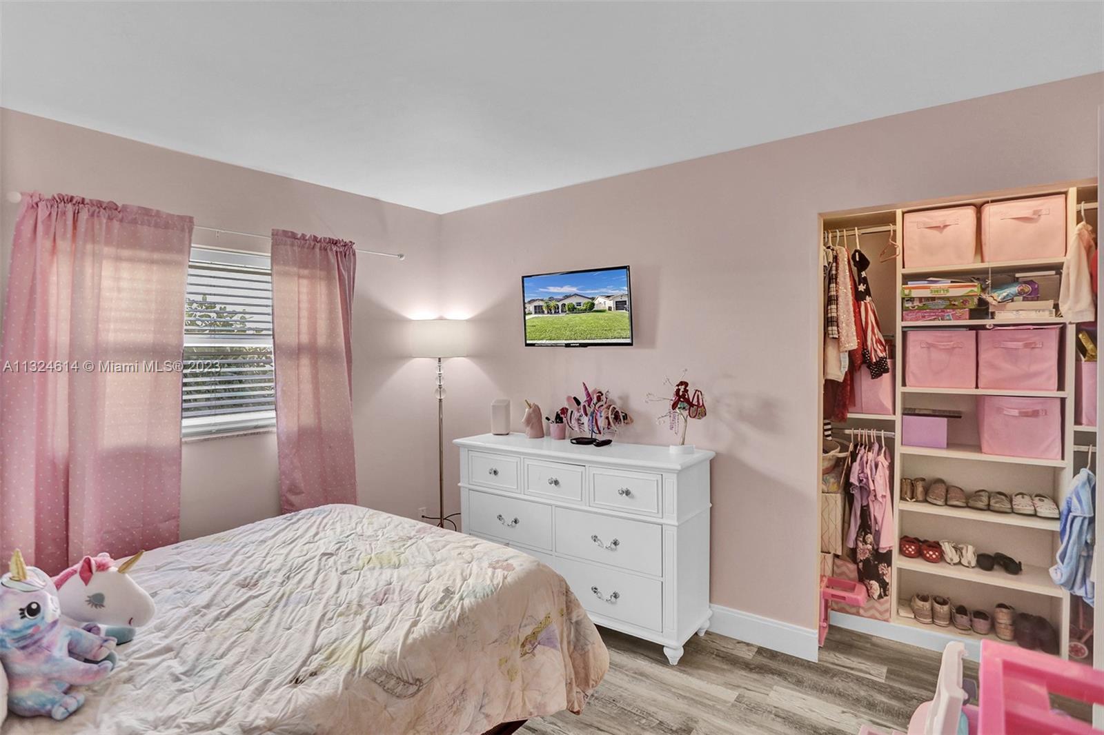 22777 Southwest 56th Avenue Boca Raton, FL 33433 - Photo 6 of 34 a bedroom with a bed and a cabinets