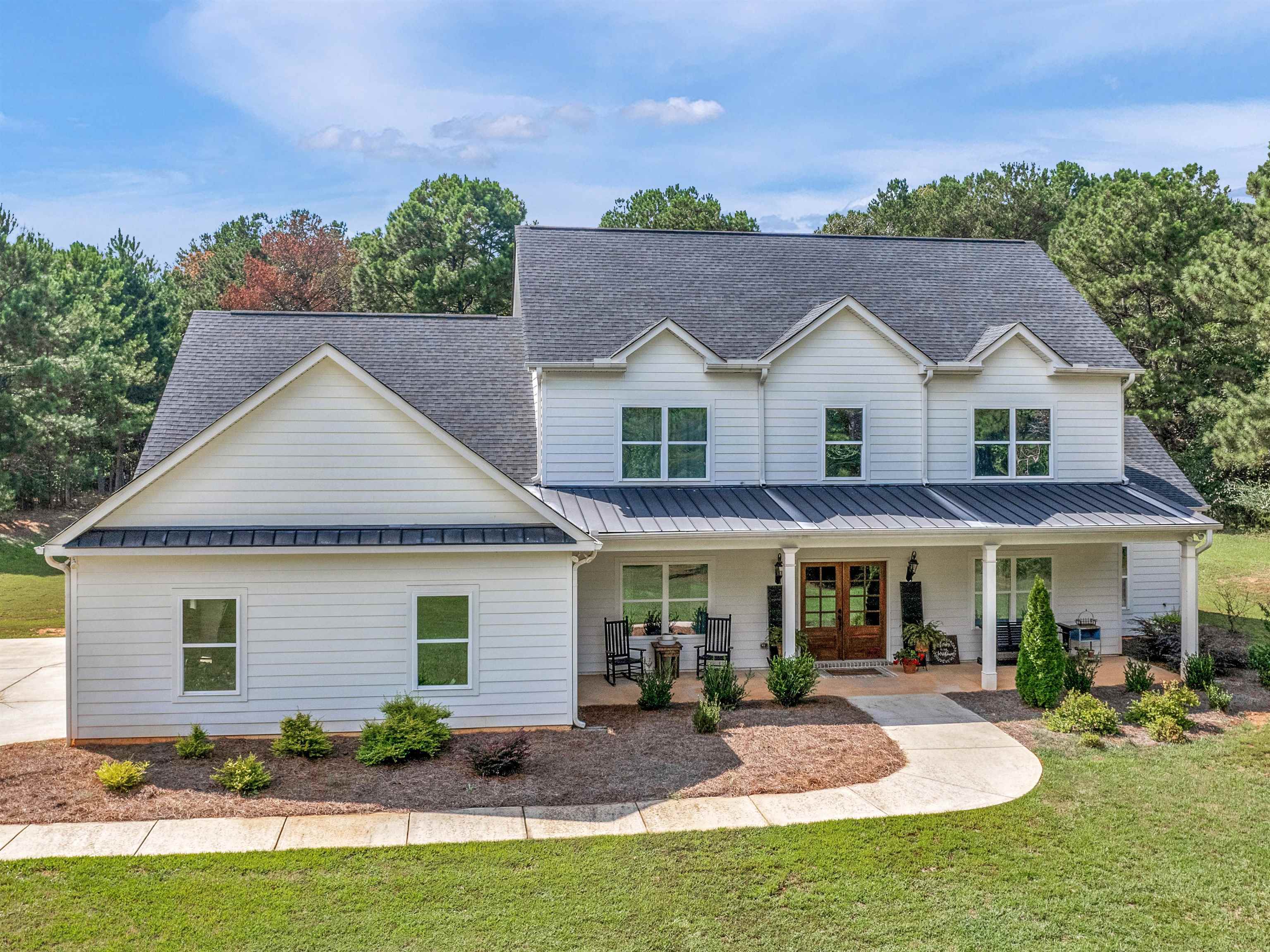 a front view of house with yard outdoor seating and green space