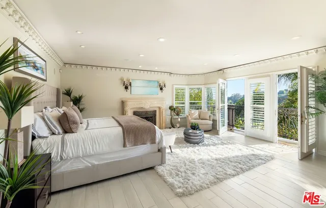 a bedroom with a large bed and a large window with outer view