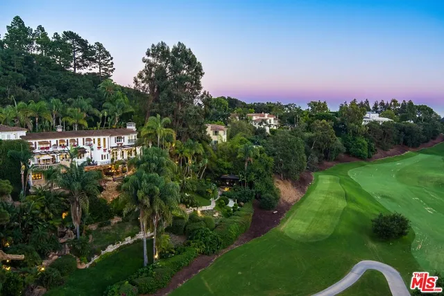 a view of a garden with a building in background