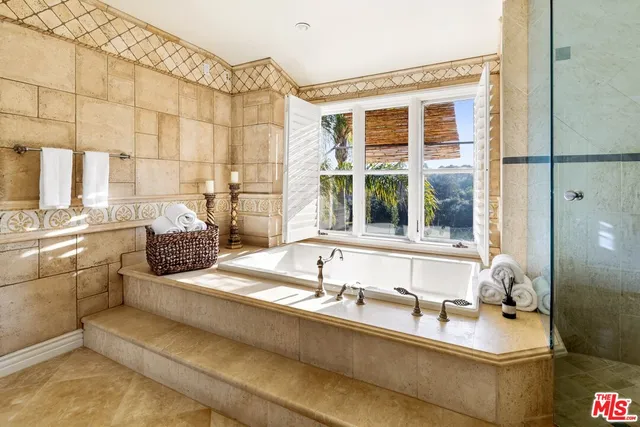 a bathroom with a granite countertop sink and a window