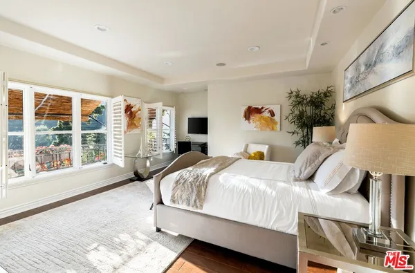 a bed room with a bed and a large window