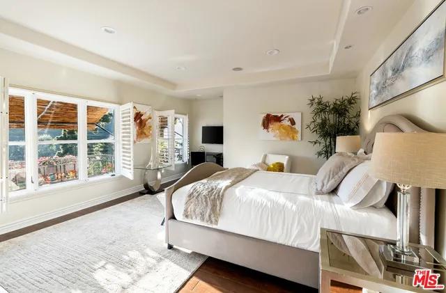 a bed room with a bed and a large window