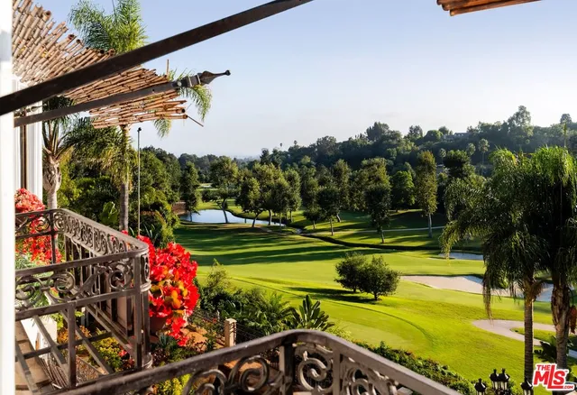 a view of a swimming pool with a garden and trees