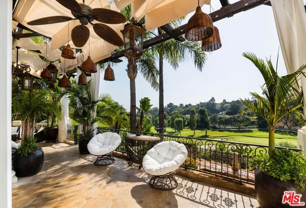 a view of a chair and tables in the patio