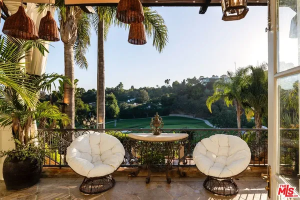 a view of a backyard with swimming pool and furniture