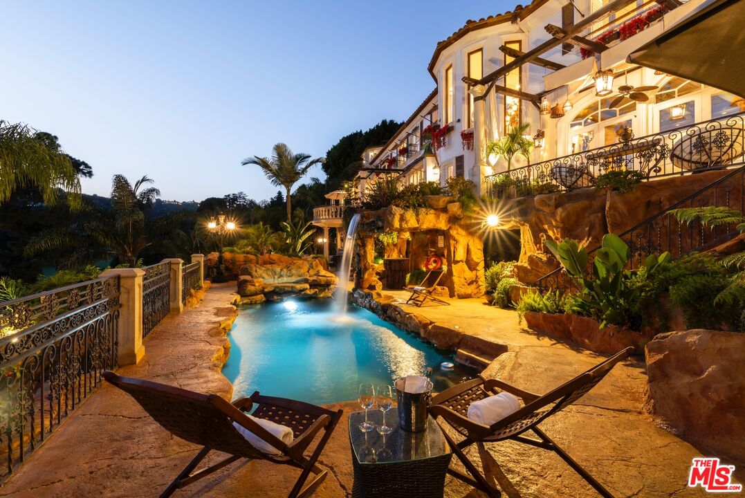10824 Chalon Road Los Angeles, CA 90077 - Photo 35 of 40 a view of a swimming pool with a patio and plants